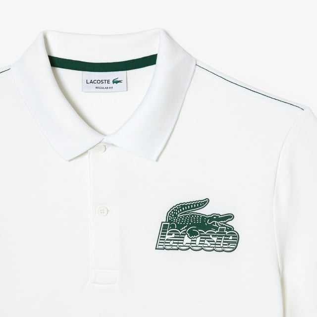Proud of Lacoste’s DNA  revisiting our iconics in a contemporary way Regular fit  natural ease on body Iconic petit pique Graphic polo 2 rubber buttons placket 3cm green crocodile at bottom garment - left side when worn Lacoste stripe gradient and crocodile print at chest