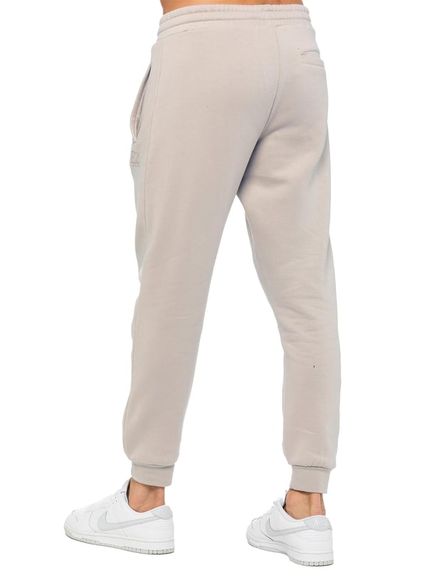 Experience ultimate comfort in our Enzo Mens Regular Fit Joggers. Made with a soft brushed back inner fleece lining, these joggers are perfect for casual wear. The cuffed leg design and elasticated waist with drawstrings provide the perfect fit. With 2 side slash pockets, you can easily carry your essentials.