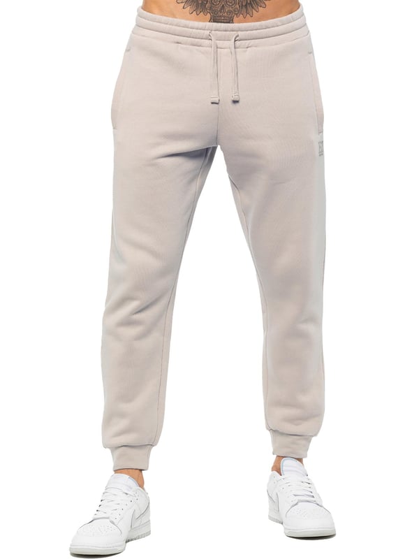 Experience ultimate comfort in our Enzo Mens Regular Fit Joggers. Made with a soft brushed back inner fleece lining, these joggers are perfect for casual wear. The cuffed leg design and elasticated waist with drawstrings provide the perfect fit. With 2 side slash pockets, you can easily carry your essentials.