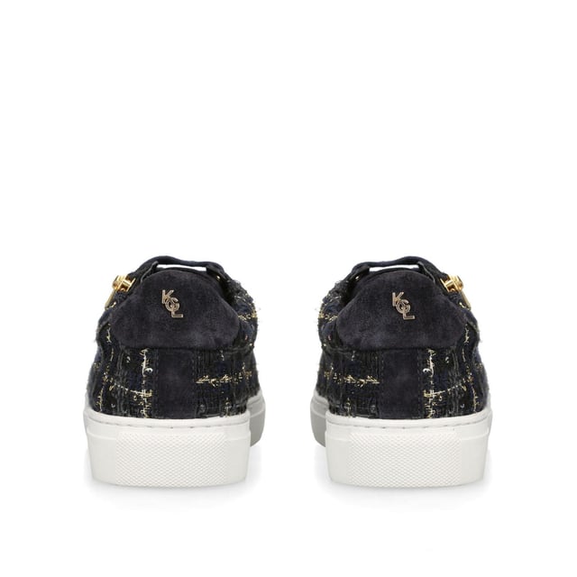 The Dulwich Zip sneaker features a navy tweed fabric upper with flecks of gold running through. The front laces up with gold eyelets to the side of a gold zip.