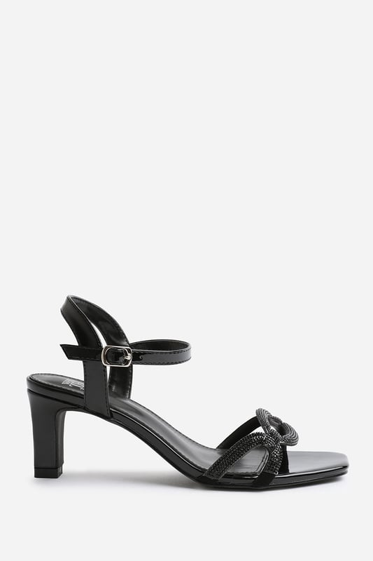 Wheres That From Womens 'Kenia' Square Toe Low Block Heel Step out in style and sophistication with our Kenia Square Toe Low Block Heel With Diamante Strap Detail. These stunning shoes are designed to elevate your outfit and add a touch of glamour to your every step.
Key Features:
Cut-Out Strap Design: The Cut-Out Strap detail adds an elegant and polished touch to these shoes, making them the perfect option for those who want to make a fashion statement.
Breathable Design: The open toe front and heel provide breathability, ensuring your feet stay cool and comfortable even on warmer days.
Comfortable Height: The mid-high block heel provides stability and support, while the cushioned insole ensures all-day comfort. Walk confidently knowing that your feet will stay comfortable, no matter where the day takes you.
Specifications:
Heel Height: 3' (7.6cm) approx
Strap Detail: Single-strap design adds elegance and polish to these shoes
Peep Toe: Stylish peep toe design adds a fashion-forward element
Closure: Buckle closure for a secure and adjustable fit
Elevate your style and make a statement with our Kenia Square Toe Low Block Heel With Diamante Strap Detail. These shoes combine fashion and functionality, allowing you to showcase your individuality while enjoying all-day comfort. Step out with confidence and embrace your inner trendsetter.