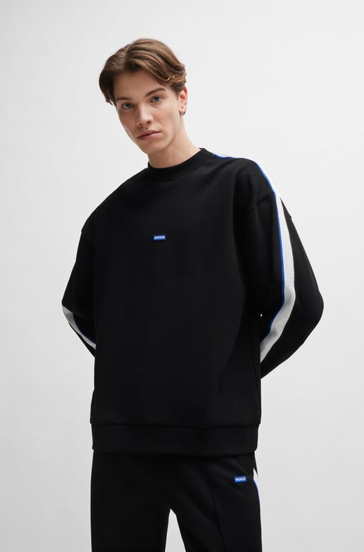 A fresh sweatshirt by HUGO Menswear. Designed in cotton terry  this regular-fit layer is trimmed with a branded patch and tape down the shoulders. mid weight french terry like rectangle logo story - HUGO BLUE logo patch on center chest - HUGO BLUE tape on arm and shoulder - ribbed collar  hem and cuffs