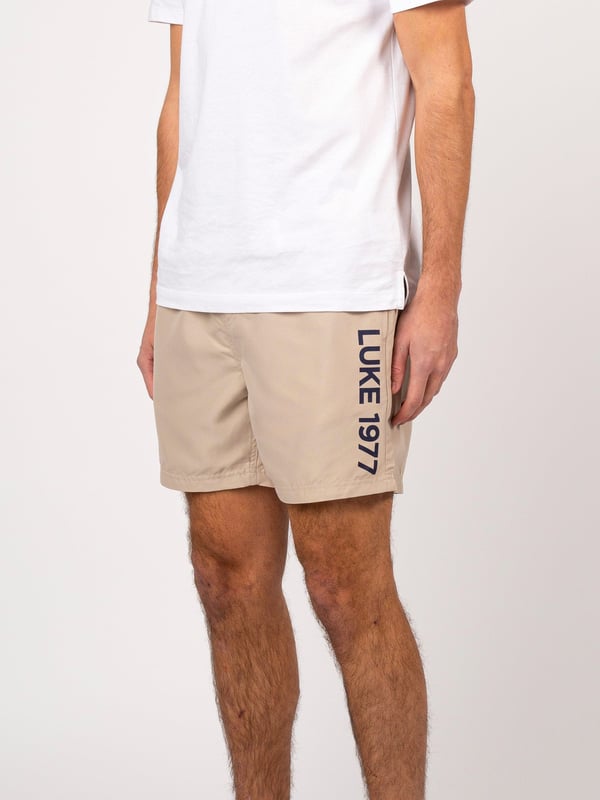 Get poolside-ready with this pair of swim shorts from LUKE. Cut from a quick-drying polyester, they feature a comfy drawcord waist and essential side entry pocket. They are complete with a contrast LUKE 1977 print down the left leg.