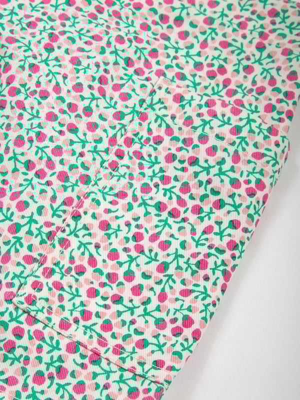 100% organic cotton | Proud to be certified to the Global Organic Textile Standard (GOTS) | Little bud all-over print | Twill fabric | Skirt with matching built-in shorts | Elasticated waistband | Made in India | Machine washable at 40 degrees, or at 30 degrees to be kinder to the planet