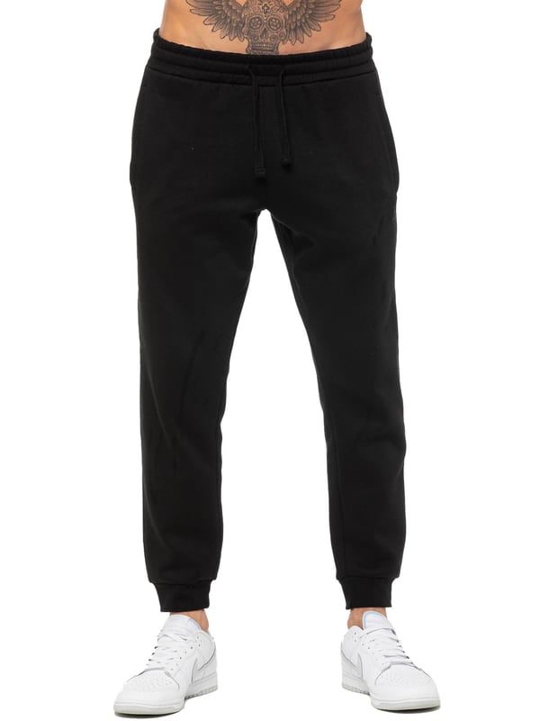 Enzo Mens Regular Fit Joggers. Elasticated Waistband With Adjustable Drawstring. Features 2 Side Slash Pockets & Single Welt Back Pocket. Cuffed Ankle. Features EZ Logo.