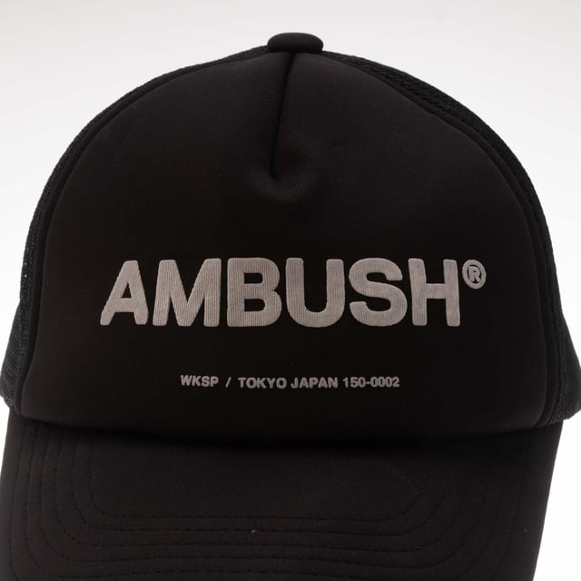 Mens Ambush Classic Logo Cap in black - white.- Trucker cap.- Curved brim.- Stretch technical fabric to front.- Mesh rear panels.- Adjustable back strap.- Ambush logo printed to front.- One size.- Fabric 1: 91% Polyester  9% Polyurethane.  Fabric 2: 100% Polyamide.  Lining: 100% Cotton.  Hand wash.- Ref: BMLB0030011003