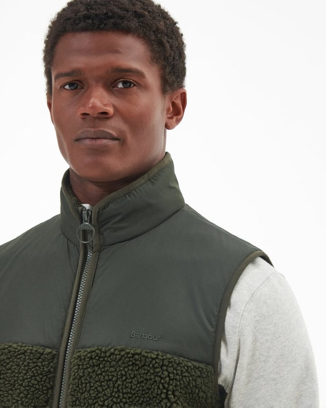 Barbour Newlan Fleece Gilet
A layering essential for the cooler months of the year, the Barbour Newlan Fleece Gilet is made from soft faux fur for a cosy look and feel. Boasting contrast panelling to the upper yoke and collar, it comes with lower welt pockets and tonal lycra binding to keep out the chill.

Barbour embroidery to left pocket
Main fabric (faux fur): 100% polyester
Secondary fabric: 100% polyester
Filling: 100% polyester
Machine wash 30?C
Back length: 70.5cm - 76.5cm

MFL0171