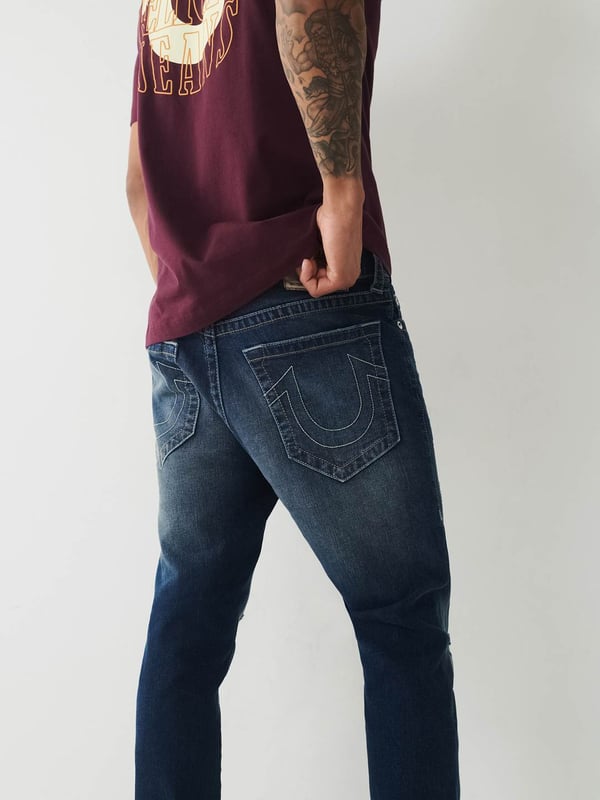 Meet our ultra-slim Jack Jean. This distressed men's super skinny jean features fading, 3D whiskering, and ripped destruction. Finished with two tone stitching, 1/2" horseshoe detailing along the back pockets, and a shorter 30" inseam.