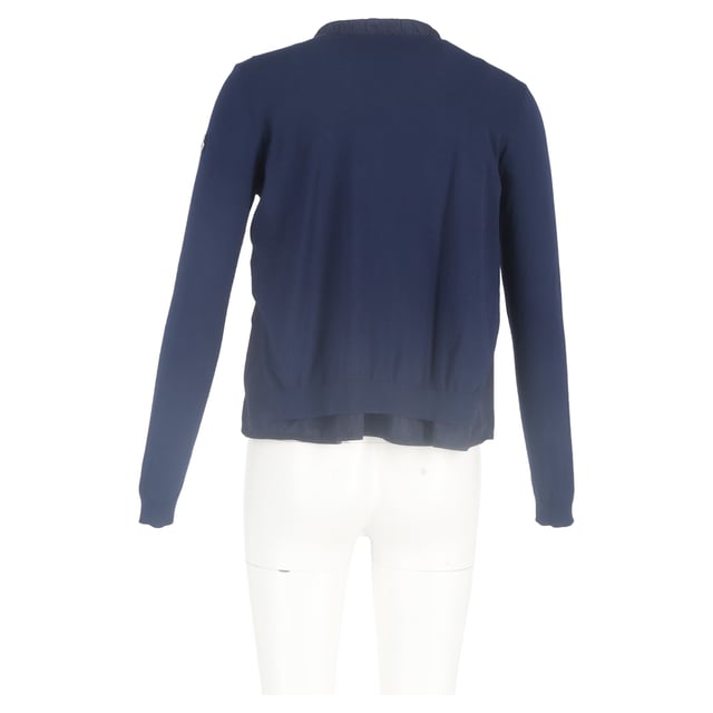 VINTAGE, RRP AS NEW
Add a touch of feminine sophistication to your wardrobe with the Moncler Ruffled Collar Zipped Cardigan in navy blue wool. This luxurious cardigan combines modern design with classic comfort, crafted from soft, breathable wool that provides warmth and a cozy feel, while the rich navy blue hue offers timeless versatility.

 Moncler Ruffled Collar Zipped Cardigan in Navy Blue Wool

Condition: Excellent
Signs of wear: No retail tag but Brand tag on., No visible sign of wear., 
Packaging: None
Color: Blue | navy blue
Material: Wool
Size: INT | L/UK14/IT46/US10/FR42
Measurements: Length: 550
SKU: NAPPUGBCL444354W