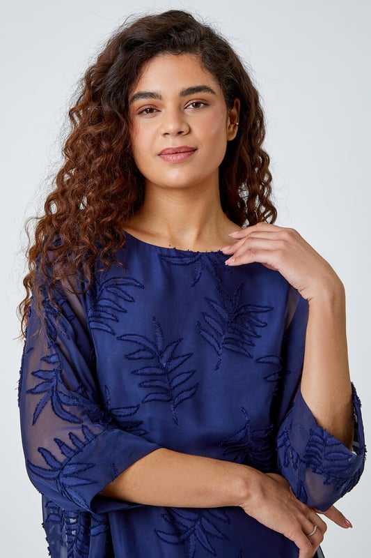 Leaf Burnout Print Chiffon Overlay Top from Roman. Dare to reveal all? Well this stunning mesh leaf embossed top is perfect for those evenings out. Featuring a round neckline with 3/4 length batwing sleeves, finished with a longer back hem and a silky cami top lining underneath for that added extra glam. Opt for faux leather leggings and heels for date night or alternatively some cropped trousers and wedges for your holiday night out.