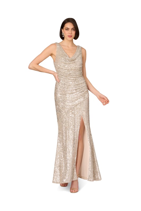 Add glamor to your next night out with this sequin gown. This formal dress features a sleeveless bodice, cowl neckline, and a mermaid skirt with a side slit. Made from stretch sequin fabric, this gown is fully lined and ultra comfortable. Gathered details at the sides creates a beautiful, shirred effect, which flatters the figure. A side zipper closure completes this evening gown. Style this sequin dress with nude heels and a satin clutch for a look that will belong in any room you walk into.