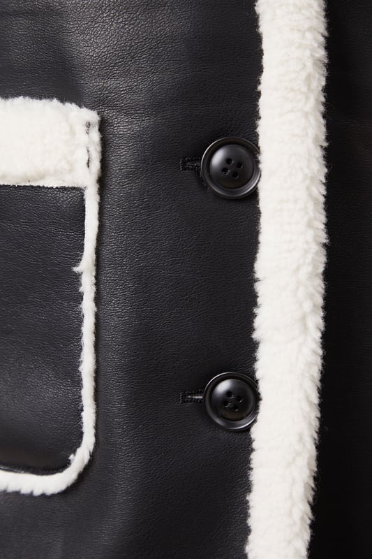 Luxurious shearling-style lining for ultimate warmth
        Oversized fit for effortless layering
        Contrasting patch pockets add a stylish touch
        Notched lapel collar for a classic look
        Long-line silhouette offers versatile styling options
    
    Embrace the chill with this striking bonded shearling coat from Oasis. The contrasting exterior and plush interior create a bold, eye-catching look that's perfect for making a statement on cooler days. Its relaxed fit allows for easy layering over your favourite jumpers and dresses, while the long-line silhouette provides ample coverage and warmth. Style it with slim-fit trousers and ankle boots for a chic daytime ensemble, or throw it over a floral midi dress for a pretty contrast at casual gatherings. The versatile design makes it an ideal choice for everything from weekend brunches to family outings. For a more polished look, cinch the waist with a statement belt to create definition and showcase your personal style.