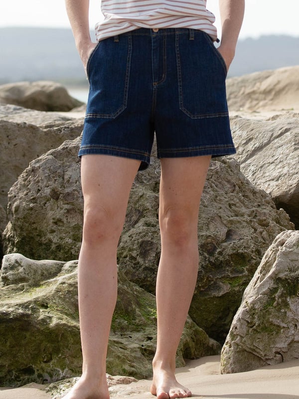 91% organic cotton 7% recycled polyester 2% elastane | Navy blue | Denim | Apple enzyme washed for a soft hand feel | Zip and coconut button opening | Large front pockets and patch pockets on back | Functional belt loops | Due to the nature of this fabric, colour may transfer to other garments and upholstery | Made in Turkey | Machine washable at 40 degrees, or at 30 degrees to be kinder to the planet