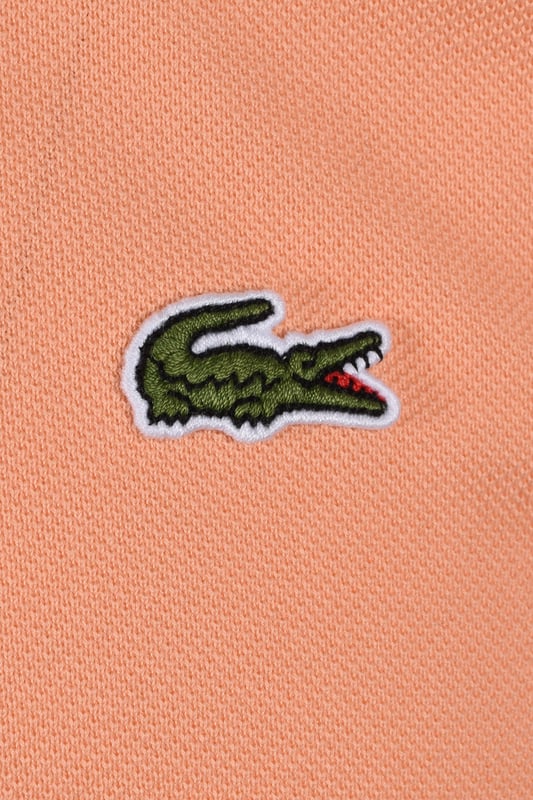 Lacoste L.12.12 Piqué Cotton Polo Peach
In 1933, Lacoste revolutionised sportswear. With a single collar, a button placket and a Pique knit, the Original L.12.12 polo was born. First ever polo shirt, the Original L.12.12 slim fit offers a Classic Lacoste Fit.

Petit Piqué, the Lacoste signature knit
Ribbed collar and sleeves
Slim fit, fitted cut
Genuine mother of pearl buttons
Embroidered crocodile sewn on the chest
Cotton (100%)
Style - L.12.12