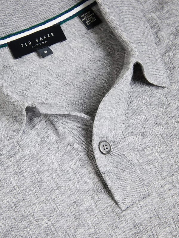 <span style="color: rgb(48, 55, 62); font-family: "IBM Plex Sans", sans-serif; font-size: 14px; white-space-collapse: preserve;">Unmatched in versatility and enduring in style, The Morar Polo is an essential in any wardrobe, effortlessly combining comfort and sophistication. Whether dressing up for a weekend affair or striving for a laid-back yet polished appearance, this polo offers the perfect solution. Boasting a timeless design with its long sleeves, diamond T stitch and classic collar, this knitted shirt is crafted from a luxurious wool blend and fastened with buttons.</span>
