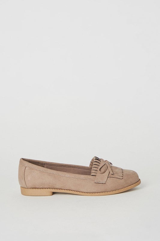 Faux leather loafers with a wide fit for added comfort
Stylish tassel detailing adorns the vamp
Moccasin-inspired stitching adds a touch of flair
Flat heel offers all-day wearability
Versatile design suitable for day-to-night occasions

Effortlessly transition from desk to dinner with these chic wide fit loafers from Dorothy Perkins. The faux leather construction exudes a polished look, while the tassel embellishments and moccasin-inspired stitching lend a touch of playfulness. Pair them with tailored trousers for a sophisticated workwear ensemble, or team them with a flowy dress for a casual yet refined weekend brunch look. With their flat heel, these versatile loafers offer all-day comfort, making them an ideal choice for any occasion.