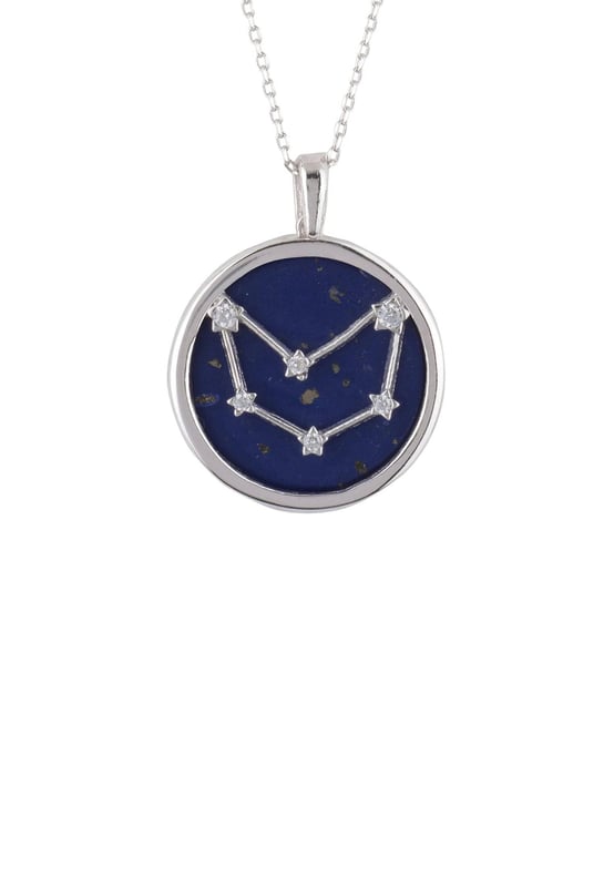 Looking for a neck piece that is out of this world? Look no further than our Zodiac Lapis Lazuli Gemstone Star Constellation Pendant Necklace Silver! The natural beauty of dark blue lapis lazuli, as wondrous as the sky at night, makes the perfect backdrop to the twinkling constellation on each pendant. Engraved with your star sign name and detailed with cut-out stars on the reverse, this pendant is sure to add a touch of starlit elegance wherever you go.Capricorns celebrate birthdays December 22 - January 19, they are hard-working, grounded and loyal individuals. They are focused on achieving their goals and are not afraid to put in a lot of effort to achieve success.Crafted from 925 sterling silver encasing a disc of Lapis lazuli, it’s a beautiful way to express your personality in fashionable form. With a diameter of 2 cm, a length of 40 cm plus 5 cm adjuster, to wear long or short and a weight of 5.3 grams, you can make this jewellery your own and create the perfect accessory for that special occasion or everyday look.So go explore the universe with our beautiful Zodiac Lapis Lazuli Gemstone Star Constellation Pendant Necklace.