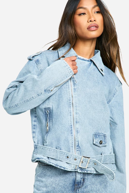 Classic biker-style denim jacket with a modern twist
        Adjustable belt detail for a customisable fit
        Asymmetrical zip closure for edgy appeal
        Notched collar and epaulettes for authentic biker look
        Functional side pockets and chest pocket for practicality
    
    Embrace your inner rebel with this contemporary take on the timeless denim jacket. The biker-inspired design combines urban edge with versatile style, making it a must-have addition to your wardrobe. Perfect for casual outings, this jacket can effortlessly transition from day to night. Pair it with high-waisted jeans and a graphic tee for a laid-back lunch date, or throw it over a floral dress to add a touch of attitude to your ensemble. The adjustable belt allows you to cinch in the waist for a more tailored silhouette or leave it loose for a relaxed vibe. Ideal for family gatherings or casual meet-ups with friends, this jacket is sure to become your go-to outerwear piece. Its durable denim construction ensures longevity, while the classic design promises to remain stylish season after season.