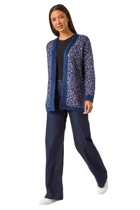 Mosiac Fluffy Trim Cardigan from Roman. Stay stylishly warm this Winter with our mosaic fluffy cardigan. This cosy piece features a unique mosaic design with a contrasting placket and cuff details, adding a touch of interest to your look. The long sleeves and secure edge to edge front provide extra warmth, while the longline length gives a flattering silhouette. Pair with a simple t-shirt and jeans for an effortlessly chic and cosy outfit.