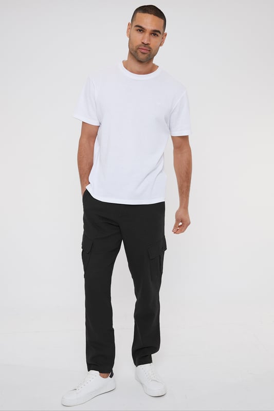 Upgrade your wardrobe with these linen blend cargo trousers from Threadbare. These linen mix cargos are the perfect blend of comfort and style, and with a part elasticated waistband with drawcords, they hit the laidback luxe trend with ease. Cut in a regular fit with a twin needle stitched hem, belt loops, mock horn button and zip fly closure. Linen-rich, these trousers will keep you cool and comfortable all day long, and have two side pockets, two back pockets, along with a button closure pocket on each leg. Team with a casual shirt to complete the look.