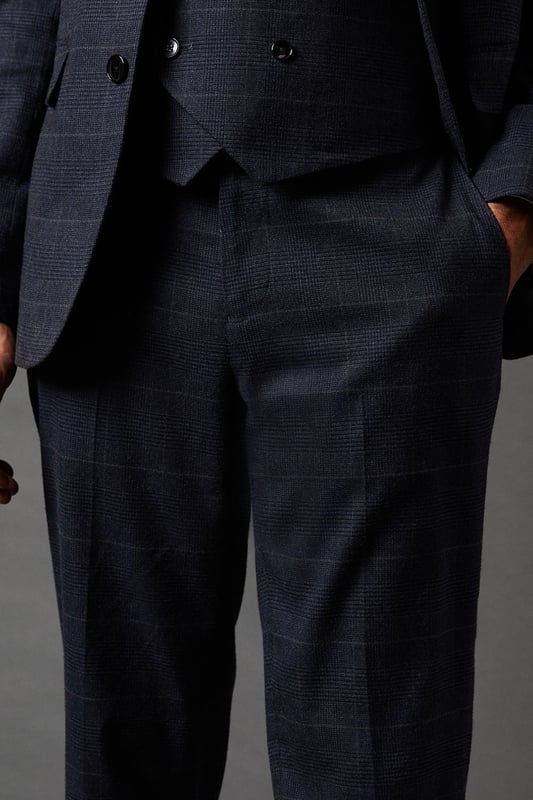 Tailored fit trousers for a refined silhouette
        Distinctive pow check pattern adds visual interest
        Side pockets for practicality
        Belt loops for versatile styling options
        Tapered leg design for a modern look
    
    These Burton pow check trousers offer a sophisticated twist on classic tailoring. The tailored fit sculpts your silhouette while providing comfort and ease of movement. Perfect for the discerning gentleman who appreciates timeless style with a contemporary edge. Pair with the matching jacket and waistcoat for a complete suit that commands attention at formal events or important business meetings. For a smart-casual ensemble, team with a crisp white shirt and leather brogues. The versatile design allows for effortless transition from day to night, making these trousers an essential addition to any well-curated wardrobe. Whether you're heading to the office, attending a wedding, or enjoying a night out at your local pub, these trousers will ensure you look polished and put-together.