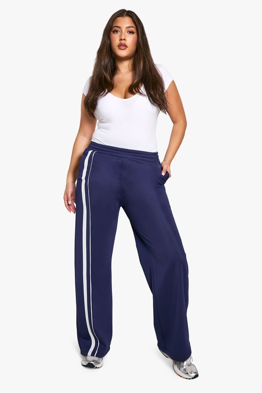 Straight fit joggers for a relaxed silhouette
        Side stripes add a sporty, contemporary touch
        Comfortable jersey fabric for all-day wear
        Wide leg design for effortless movement
        Versatile style suitable for various casual occasions
    
    Embrace comfort without compromising on style with these plus-size joggers from Boohoo. The straight fit and wide leg design offer a flattering silhouette while ensuring unrestricted movement. The side stripes lend a trendy, athletic-inspired look that's perfect for the fashion-forward woman. Pair these versatile joggers with a fitted white tee and trainers for a laid-back daytime ensemble, or dress them up with a cropped jacket and statement jewellery for a chic evening out with friends. The soft jersey fabric makes these joggers ideal for lounging at home, running errands, or attending casual family gatherings. For a coordinated look, match with the hoodie as shown in the image, completing an outfit that's both cosy and stylish. These joggers are a must-have addition to your wardrobe, offering endless styling possibilities for the modern, confident woman who values both comfort and fashion.
