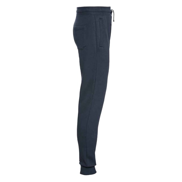 80% gekamd ringgesponnen katoen, 20% polyester. 280gsm. Ontwerp: Eenvoudig. Omgeslagen enkel, geribde tailleband. Lengte: Enkel. Zakken: 2 Zijzakken, Rits, 1 Achterzak. Taille: Koord, Elastisch. Duurzaamheid: Amfori, BSCI, Oeko-Tex Standaard 100 Gecertificeerd. Manchet: Ribbel.