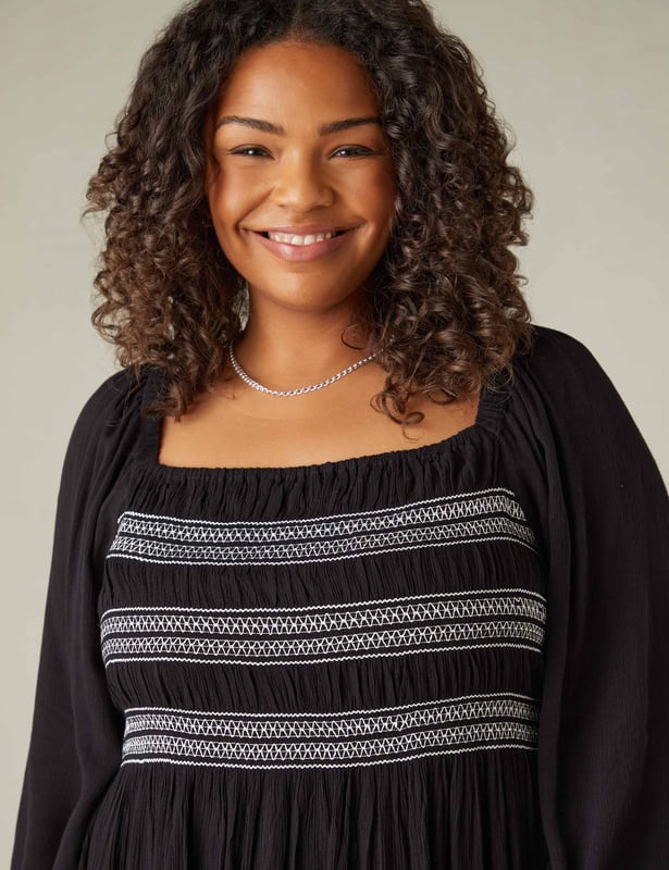 In classic black, this dress is cut from a soft, textured fabric thats so comfortable to wear. With elasticated shirring through the bodice in contrasting white, it has a flattering square-neck shape. Elastication around the neck and shoulder heads ensures comfort, while a cross-shoulder tie prevents the full-length sleeves from falling down. It has a stylish midaxi shape with a flowy skirt, making this the perfect warm weather piece.