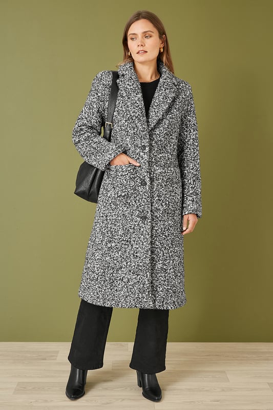 Amazing outerwear will see you through the season in style. This long line over coat is perfect for everyday wear. In a gorgeous boucle fabric that is both style and cosy, the simple and elegant design is a classic. With a collared neckline and deep front pockets.