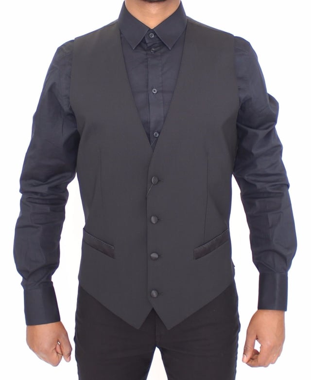 <p>Dolce &amp; Gabbana Vest</p>
<p>Absolutely stunning, 100% Authentic, brand new with tags Dolce &amp; Gabbana black wool silk blend stretch Dress Vest. This item comes from the MainLine Dolce &amp; Gabbana collection.</p>
<p>Modell: Single breasted<br />
Strap: Adjustable back waist strap<br />
Color: Black<br />
Full front button closure<br />
Logo details<br />
Made in Italy</p>