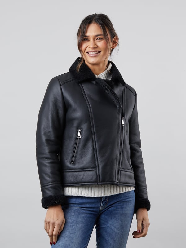 Lindeth Sheepskin Aviator Jacket in Black Our new-in flattering Lindeth aviator jacket is crafted in rich sheepskin with a smooth external nappalan finish. The black colourway is elegant and timeless and you can pair this jacket easily with your favourite knits to stay cosy all winter long.Featuring an asymmetric zip front inspired by biker jackets, the snuggly lapel collar and cuffs will keep you warm and cosy when the chilly weather comes around. Plus you can keep your hands extra warm with two handy front zip pockets.Sheepskin is nature's finest insulator and temperature regulator, meaning you will stay unbelievably warm and comfortable without overheating. The Lindeth jacket truly is the perfect investment for years to come.Sizing InformationThese measurements are based on a size 12 and will vary slightly between sizes.Approximate centre back length: 61cmApproximate sleeve length from shoulder to cuff: 62cm Approximate sleeve length from underarm to cuff: 45cmThe DetailsStyle Name: Lindeth Sheepskin Aviator JacketColour: BlackMaterial: 100% sheepskin with a nappalan finishFit: True fitAsymmetric front zip fasteningSheepskin lapel collarTwo front zip pocketsSheepskin cuffsAnd on the inside100% sheepskin