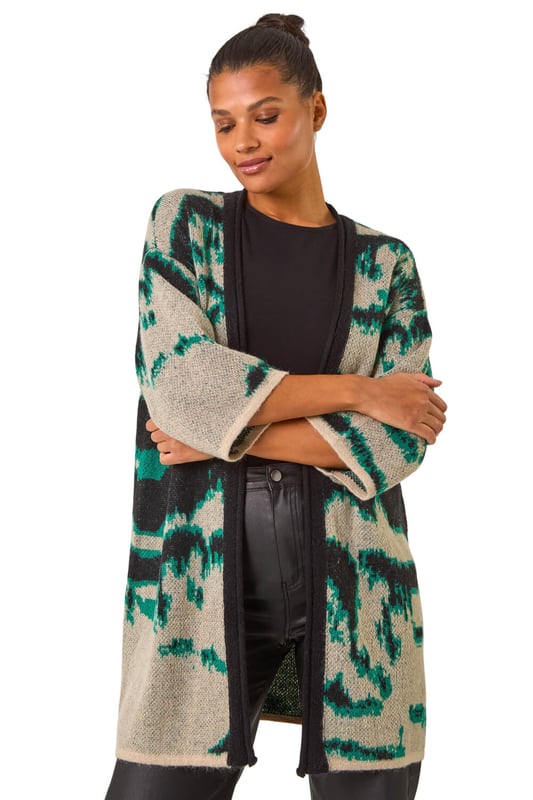Abstract Print Knit Cover Up from Roman. Stay stylish and warm with this abstract knit cover up, perfect for the Autumn/Winter season. Designed with an eye catching abstract knit pattern, this cover up features an easy edge to edge front and chic short sleeves for a versatile look. Layer it over a long sleeve top and jeans for a fashionable and cosy outfit.