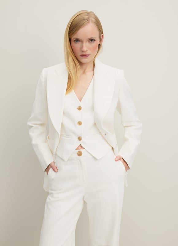 The perfect summer suit, the Avery jacket teams up with the matching waistcoat and trousers, but can also be worn to loosen up dresses or over jeans and a tee. Crafted in Portugal from beautiful Italian cotton in soft and textured cream, it has a straight cut, a wide, curved lapel, horn-effect buttons and large patch pockets to the front. Wear it with a pussy bow blouse and the Ami trousers or shrug it over a floral dress.