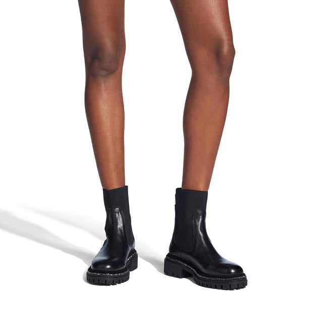 The Dazzle ankle boot is crafted from a black leather with black elasticated fabric at the ankle. The ankle features an antiqued silver Signature C pin as well as pull tab.  Heel height: 40mm.