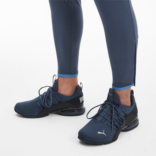 PRODUCT STORY Be bold in the game-changing silhouette of our Axelion Block Running Shoes, which combine contemporary design with the supreme comfort of our foam heel unit for the last word in athletic style. DETAILS   Low boot   Textile upper   Foam heel   TPU shank   Rubber outsole   PUMA Cat Logo at toe