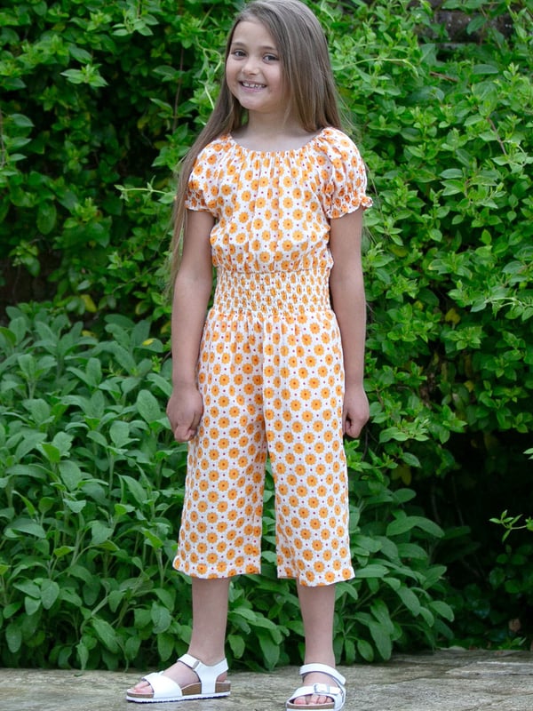 100% organic cotton |  Proud to be certified by Control Union to the Global Organic Textile Standard (GOTS) |  Groovy dot all-over print |  Orange |  Double layer muslin fabric |  Side pockets |  Short sleeved |  Elasticated shirring at waist and sleeves |  3/4 length leg, culotte style legs |  Elasticated neckline |  Made in India |  Machine washable at 40 degrees, or at 30 degrees to be kinder to the planet