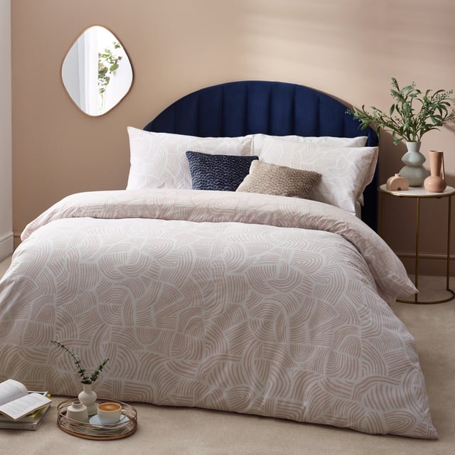 Enjoy a comfortable night’s sleep in the Dunes duvet cover set, inspired by modern, minimalist and abstract art. It features an intricately swirling, abstract line printed design, reminiscent of drifting sand dunes. The reverse reveals an inverted colourway for a more defined look, making it ideal for a midweek refresh if desired. A simple and timeless addition to your bedding collection. This product is certified by OEKO-TEX® showing it has been sustainably made.