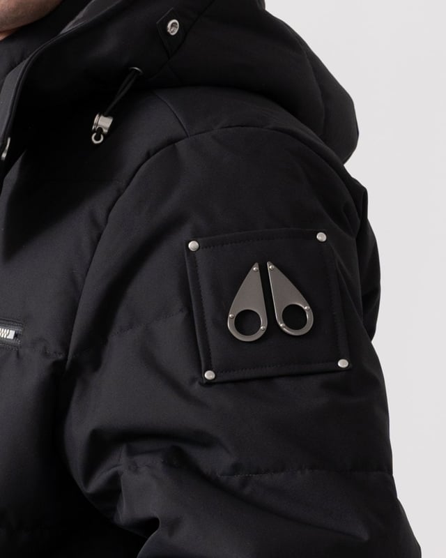 The Cloud Bomber boasts a 30% weight reduction compared to Moose Knuckles Originals, providing lasting warmth without added bulk. Crafted from lightweight shell and RDS-certified 90/10 down fill, it features a hollow frame logo for maximum warmth in a lightweight package. Its removable lamb shearling-trimmed hood adds versatility, while heat-retaining brushed pockets at the front enhance functionality.


Warmth & Protection


Protection Rating - Level 3: Crazy Cold – Heavy and durable, choose these garments when the cold gets serious.
800 Fill Power
Toscana Shearling on Trim
Water Repellent, Water Resistant, Wind Resistant




Design & Function


Capuchon amovible
Down Filled Collar
2- Way Zipper with Logo Puller
2 Pockets with Zipper Closure on Chest2 Pockets with Zipper Closure below Waist
Rib Knit Cuffs and Hem
Black Nickle Metal Logo


COMPOSITION



Body: 100% Polyester
Lining: 100% Polyester


FILL

90% Duck Down 10% Feathers
 
M34MB005S


 



 



 