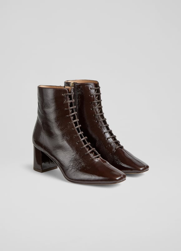 Experience sophistication with every stride. Our Arabella lace-up ankle boots in rich espresso crinkled patent boast a stylish square toe and a sturdy block heel, all exquisitely lined with leather. Perfect for smart-casual ensembles, pair them with tailored trousers or your favourite dress. These lace-up ankle boots are the epitome of style and function. Made in Spain.