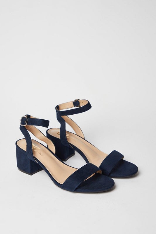 Wide fit design offers a comfortable and accommodating fit
Barely-there strappy silhouette with minimalist appeal
Mid block heel provides a modest lift and walkable height
Faux leather upper exudes a look and feel
Ankle strap with buckle closure ensures a secure fit

These versatile sandals are perfect for casual daytime outings or relaxed evening affairs. Pair them with a flowy midi dress or cropped trousers for a chic, on-trend look that transitions seamlessly from brunch with friends to an evening baby shower. The neutral hue complements a variety of ensembles, allowing you to showcase your personal style effortlessly.