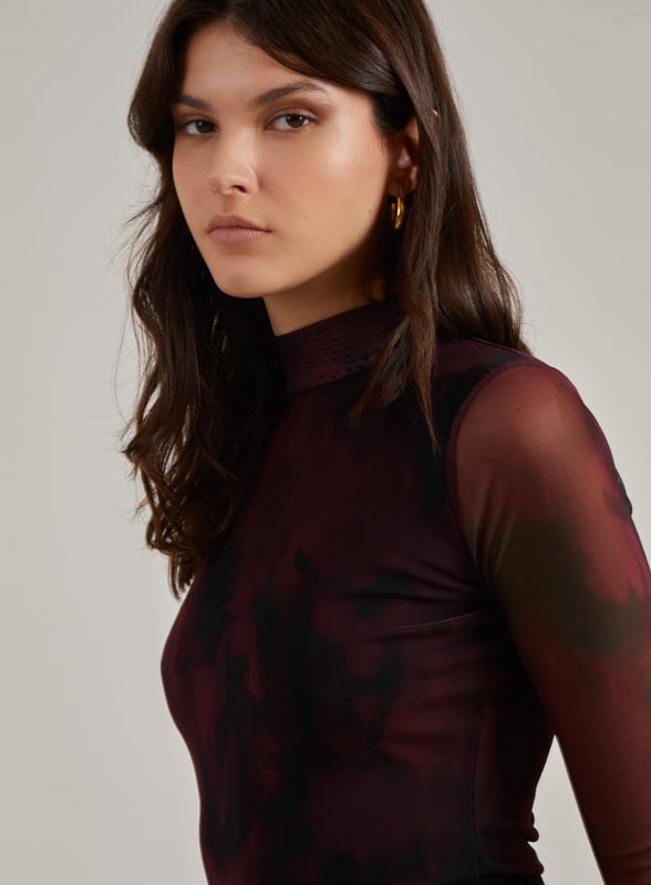 This Smudge Print Bodysuit is all you need to make a statement. Pair with knee high boots and distressed jeans for a killer look.