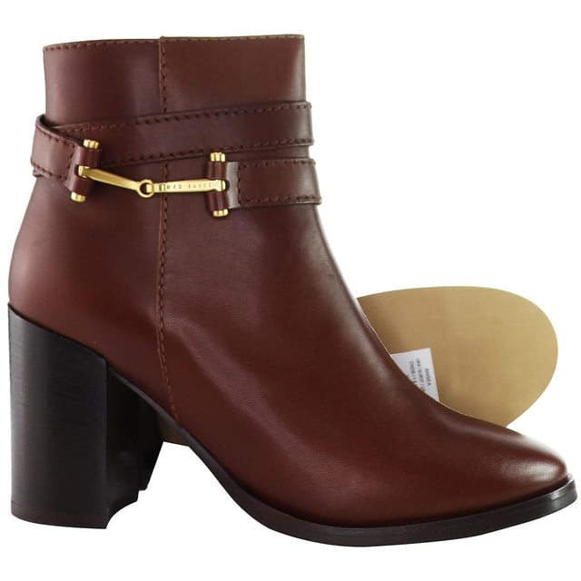 Indulge in the intersection of chic style and contemporary flair with the Ted Baker Anisea T-Hinge Women's Ankle Boots. Elevating your footwear collection with a perfect blend of sophistication and modern design, these ankle boots are sure to make a bold fashion statement.

Key Features:

 T-Hinge Embellishment:  The Ted Baker Anisea Boots feature the distinctive T-Hinge embellishment, a signature element that adds a touch of glamour and uniqueness to the ankle boots. This stylish detail not only catches the eye but also reflects Ted Baker's commitment to intricate design.

 Ankle Boot Silhouette:  Embrace a sleek and versatile silhouette with these ankle boots. The shorter height allows for easy pairing with a variety of outfits, making them a versatile choice for both casual and more formal occasions.

 Comfortable Fit:  Experience comfort without compromising style. The Anisea Boots are designed to provide a snug and comfortable fit, allowing you to walk with confidence throughout the day.

 Side Zipper Closure:  Effortlessly slip into these ankle boots with the convenient side zipper closure. This practical feature not only ensures easy on-and-off wear but also maintains the clean lines of the design.

Step into a world of fashion-forward elegance with the Ted Baker Anisea T-Hinge Women's Ankle Boots â€“ a perfect choice for those who appreciate distinctive design, luxurious materials, and versatile styling options. These boots effortlessly embody the essence of Ted Baker's commitment to timeless yet contemporary footwear.