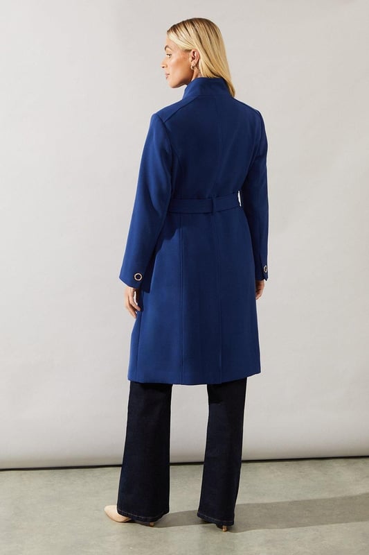 Elegant funnel neck design for a sophisticated silhouette
        Double-breasted front with stylish metallic buttons
        Flattering belted waist to accentuate your figure
        Long sleeves with button detailing at the cuffs
        Versatile mid-length cut suitable for various occasions
    
    This smart funnel neck coat from Wallis is the epitome of refined style. Perfect for the woman who appreciates sophistication with a touch of glamour, this coat is designed to make a statement. The double-breasted front with its eye-catching metallic buttons adds a luxurious touch, while the belted waist creates a flattering silhouette. Style it over sleek trousers and a blouse for a polished office look, or wear it atop an elegant dress for formal events. The versatile mid-length cut ensures you'll look put-together whether you're attending a business meeting or heading to a dinner party. Pair with heeled ankle boots and a structured handbag to complete your ensemble. This coat is a wardrobe essential that effortlessly transitions from day to night, embodying the Wallis woman's desire for comfort without compromising on style.
