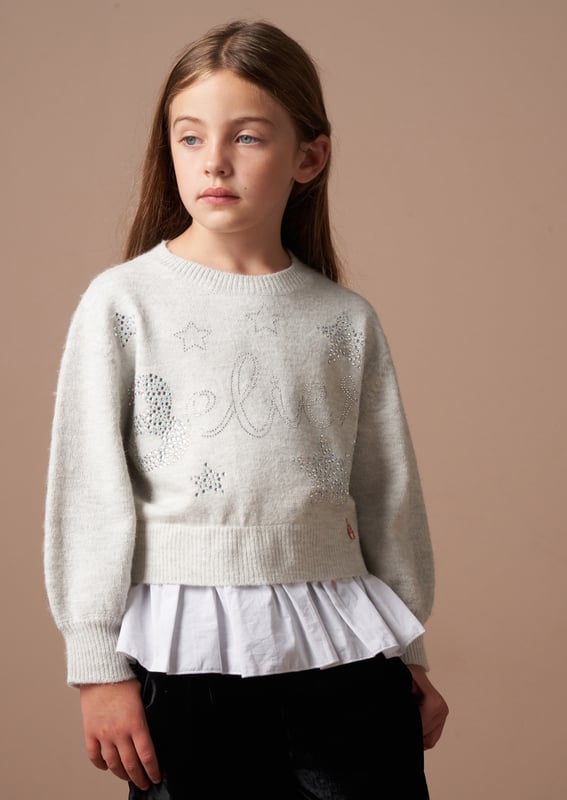 Is this the most perfect Winter knit? You sweater BELIEVE it! Crafted from soft   yarn and encrusted with stunning jewels. it also features a mock shirt panel for ultimate style credits.
