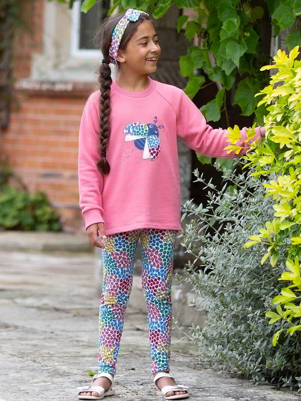 Come fly with me! Our ladybird sweatshirt is sure to brighten any day and is the perfect companion for days spent adventuring and exploring. Stylish and practical with a lovely ladybird ditsy appliqué on super soft pink lemonade brush back sweat fabric. Coconut button raglan sleeve opening up to and including size three years.