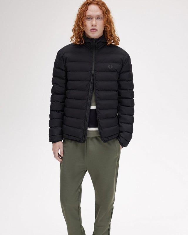 A staple Fred Perry insulated jacket with an adjustable hood and twin tipping to the internal collar.

Recycled polyester ripstop fabric 
Regular fit
Two way zip with branded puller 
Zip-up side seam pockets 
Laurel Wreath embroidered logo on the left hand chest

100% Recycled Polyamide
J8553