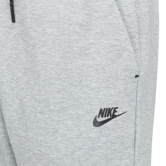 Nike Sportswear Tech Fleece Full Zip Tracksuit Grey Upgrade your wardrobe with the Nike Sportswear Tech Fleece Tracksuit Set, designed for modern comfort and style. Featuring the iconic Tech Fleece Full-Zip Hoodie and Tapered Joggers, this set offers premium warmth without the bulk, making it an essential choice for everyday wear and casual outings.
Key Features:
Tech Fleece Fabric: Engineered with lightweight, double-sided fabric for superior insulation and a sleek, streamlined appearance.
Full-Zip Hoodie:
Panelled hood for enhanced coverage and warmth.
Split kangaroo pockets for convenient storage.
Durable, bonded zipper with a smooth glide and signature tape detailing.
Tapered Joggers:
Tapered fit with ribbed cuffs for a clean, modern silhouette.
Zippered side pocket with bonded trim for secure storage of small essentials.
Elastic waistband with an adjustable drawcord for a personalised fit.
Composition:
Body: 66% Cotton / 34% Polyester
Pocket Bag Palm Side: 69% Cotton / 31% Polyester
Pocket Bag Knuckle Side: 100% Cotton
Why You’ll Love It:
The Nike Sportswear Tech Fleece Tracksuit Set is designed to keep you warm while maintaining a lightweight feel. The hoodie’s structured hood and sleek zipper details complement the joggers' tapered leg for a streamlined, stylish finish. Whether you're on the go or relaxing, this tracksuit offers the perfect combination of functionality and fashion.
Pair it with your favourite Nike sneakers for an effortlessly cool look.