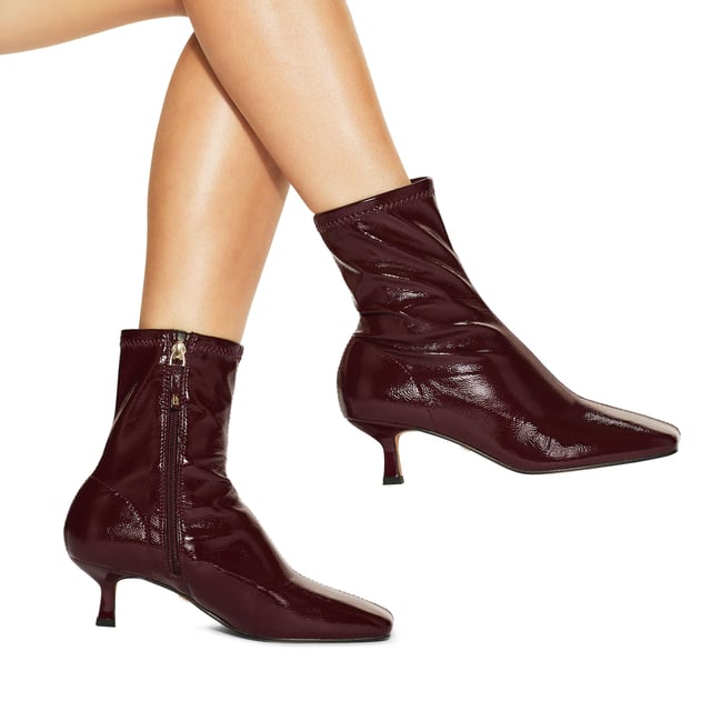 This Tact ankle boot features a patent red upper. The toe is squared with a soft ankle for comfort. Heel height: 5.5cm.