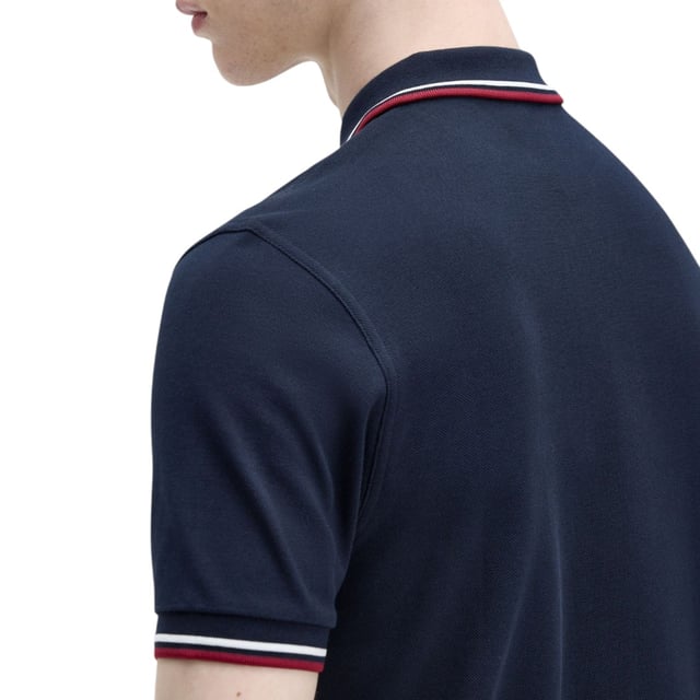 The Twin Tipped Fred Perry Polo Shirt by Fred Perry is a short sleeved polo shirt that has been made from Fred Perry's classic cotton piqué, in a contemporary adaptation of Fred's famous streamlined fit. Available in a diverse range of colourways - each with their own unique story. Featuring the signature Fred Perry wreath logo to the chest and twin tipping to the collar and cuffs.
