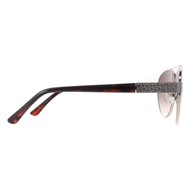 Guess Aviator Womens Gold Brown Gradient GF0414  Sunglasses feature a stylish, oversized frame made from high-quality acetate, providing a bold yet elegant look while ensuring durability and comfort. The lenses offer superior UV protection, effectively shielding your eyes from harmful rays and reducing glare. Adorned with the signature Guess logo on the temples and available in a variety of modern color options, the GGF0422 sunglasses add a touch of glamour to any outfit.